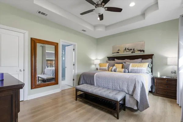 a bedroom with a bed and flat screen tv