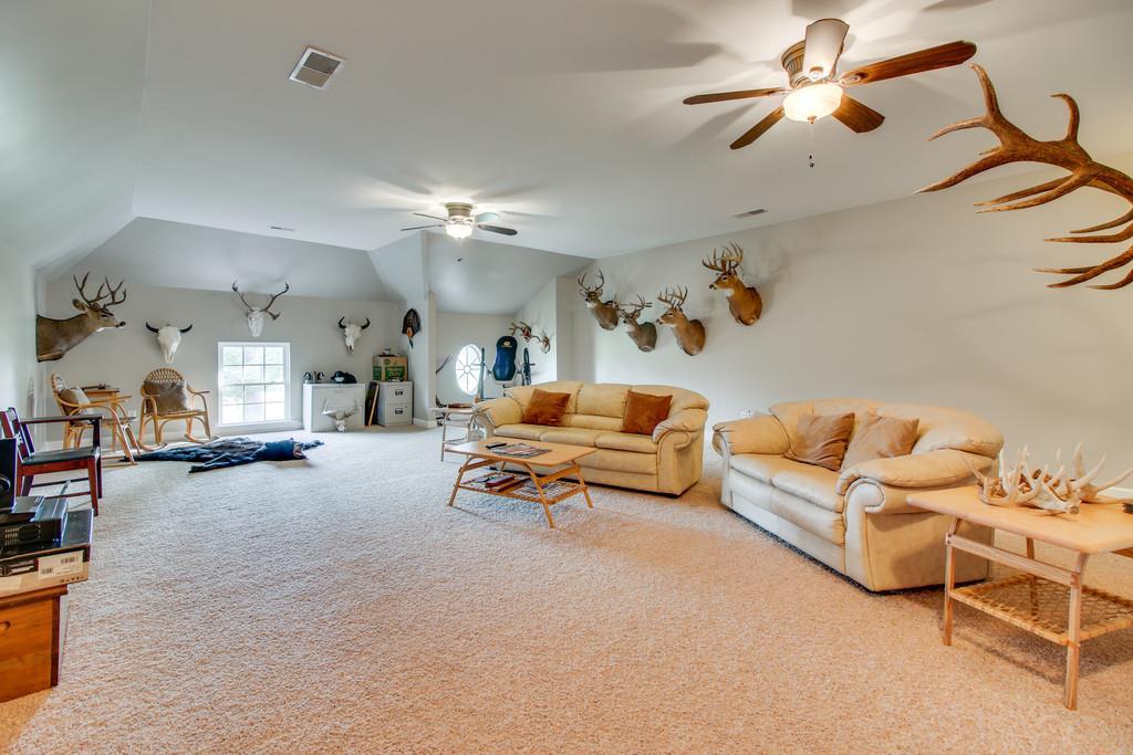 1002 Hallcrest Road Burns, TN 37029 - Photo 25 of 30 a living room with furniture and a chandelier