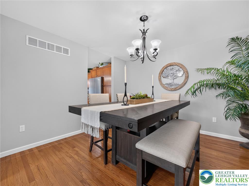 4148 Ross Road Bethlehem, PA 18020 - Photo 48 of 67 Hardwood floors and an elegant chandelier elevate this contemporary dining area.