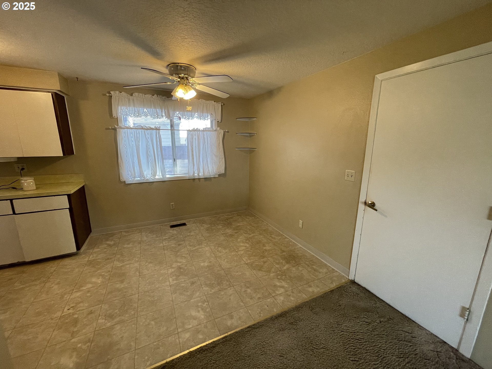 490 Northwest 3rd Street Hermiston, OR 97838 - Photo 7 of 15 a view of a livingroom with a chandelier fan and kitchen view