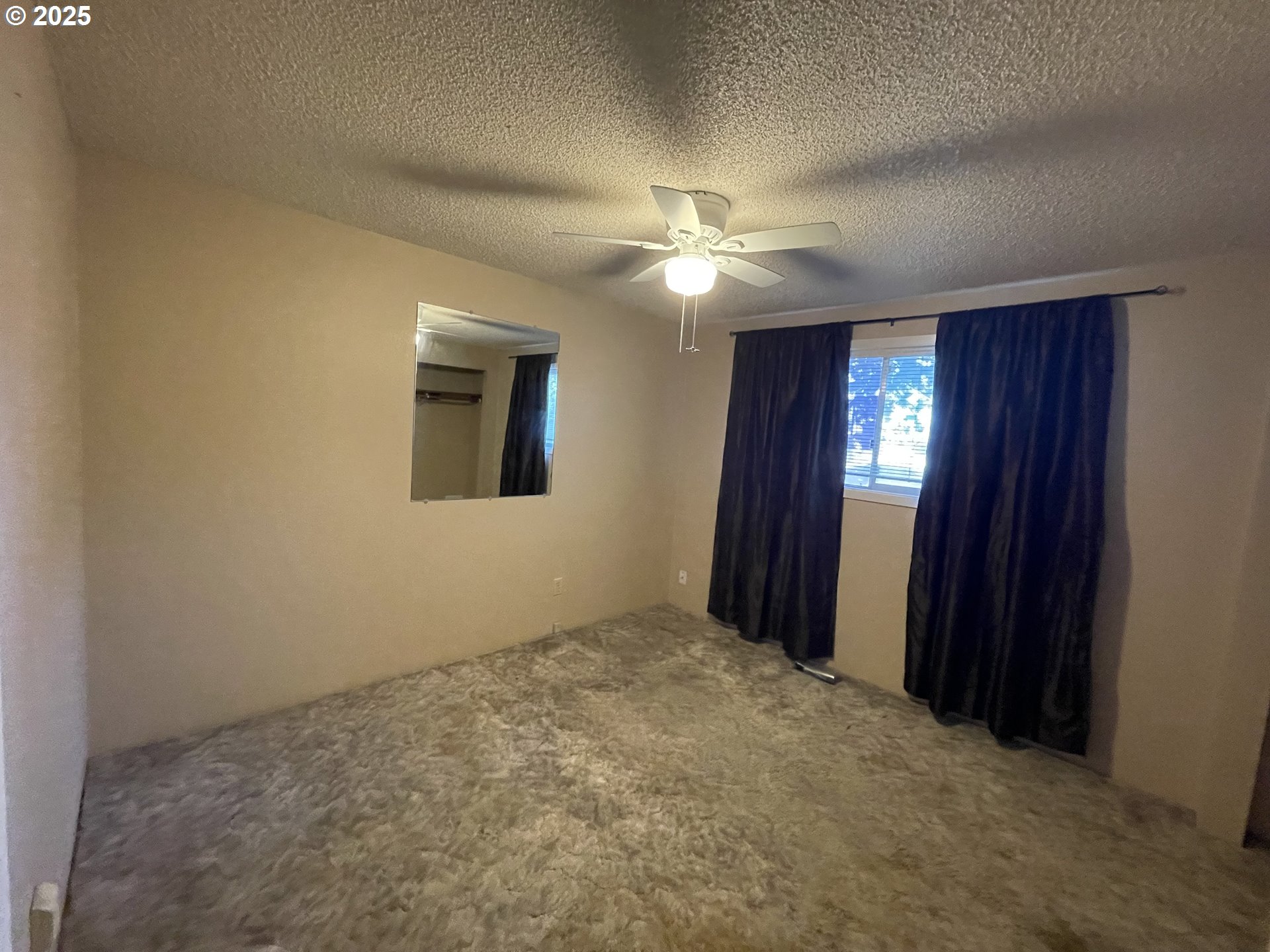 490 Northwest 3rd Street Hermiston, OR 97838 - Photo 8 of 15 an empty room with windows and fan
