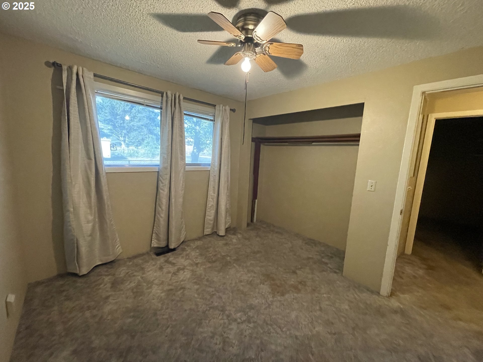490 Northwest 3rd Street Hermiston, OR 97838 - Photo 10 of 15 a view of a livingroom with a chandelier fan and windows