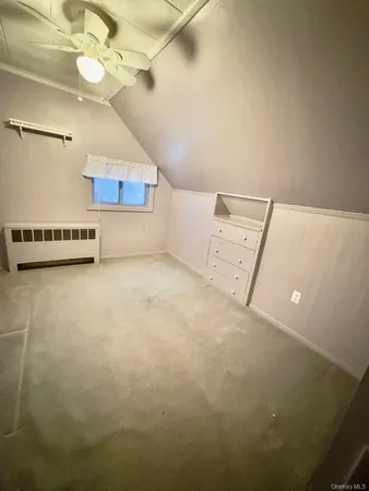 a view of a room with projector and kitchen
