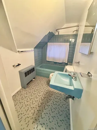 a bathroom with a sink toilet and mirror