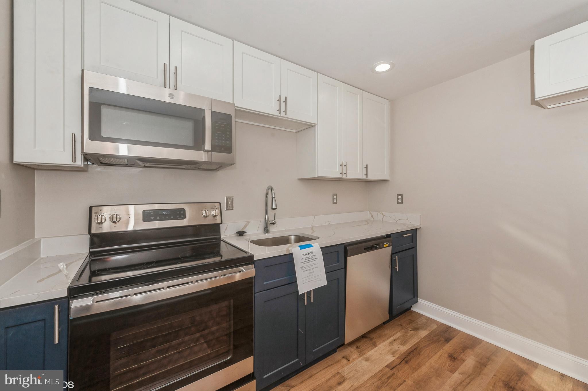 6236 The Alameda Baltimore, MD 21239 - Photo 6 of 15 a kitchen with stainless steel appliances granite countertop a stove and a microwave