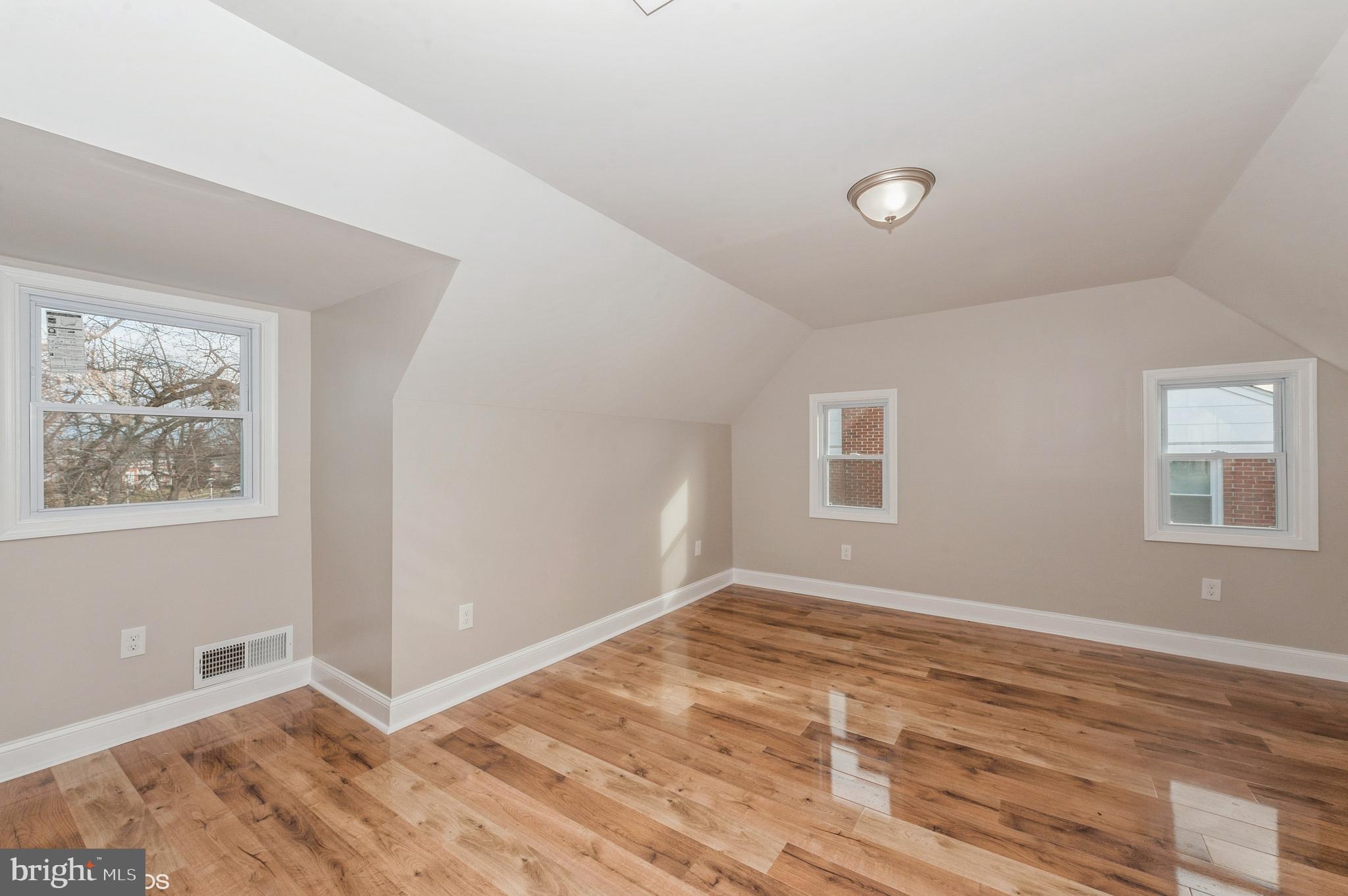6236 The Alameda Baltimore, MD 21239 - Photo 10 of 15 a view of an empty room with wooden floor and a window
