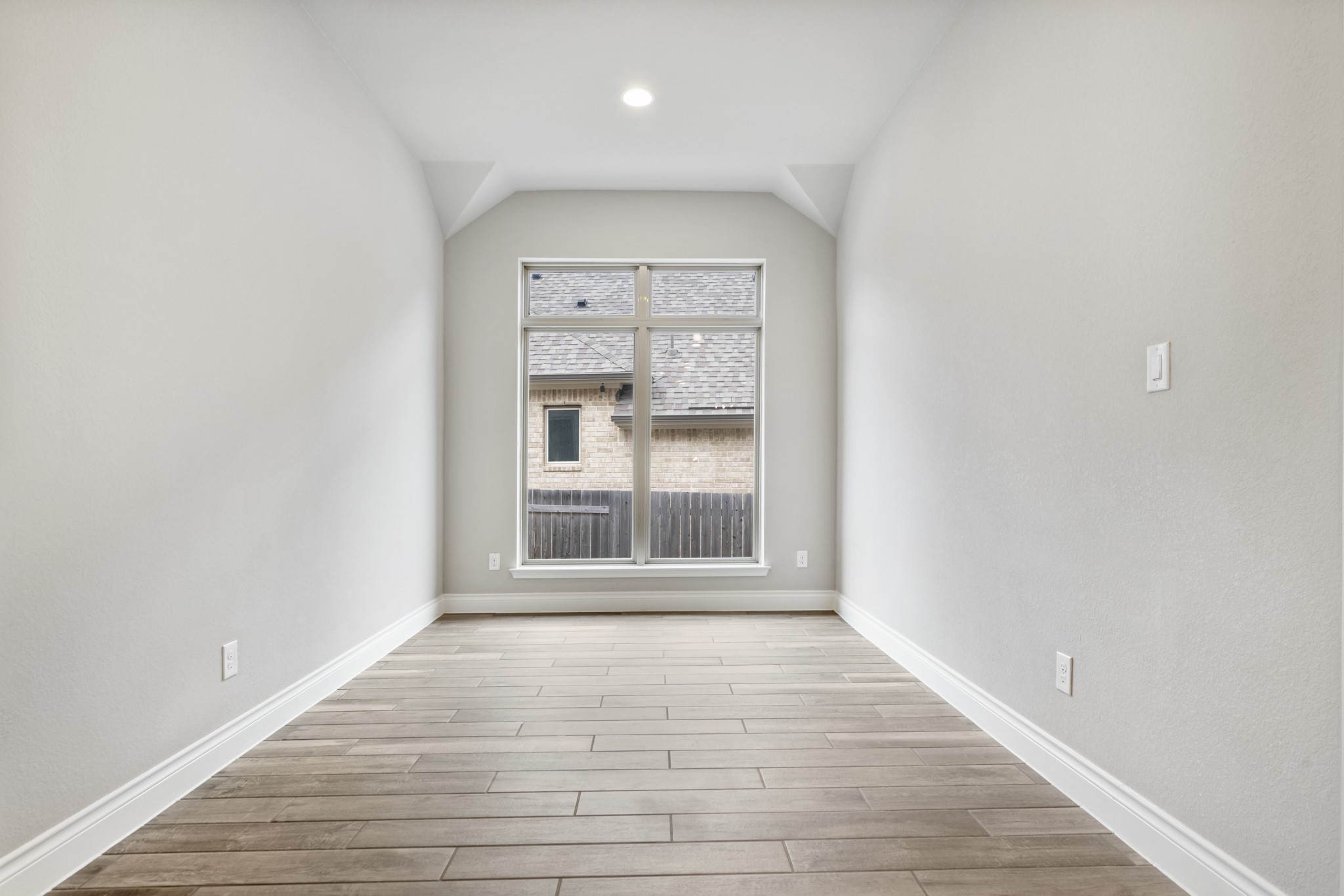 104 Catani Loop Georgetown, TX 78628 - Photo 26 of 34 This bright room features light-colored walls, wood-look tile flooring, and a large window providing natural illumination