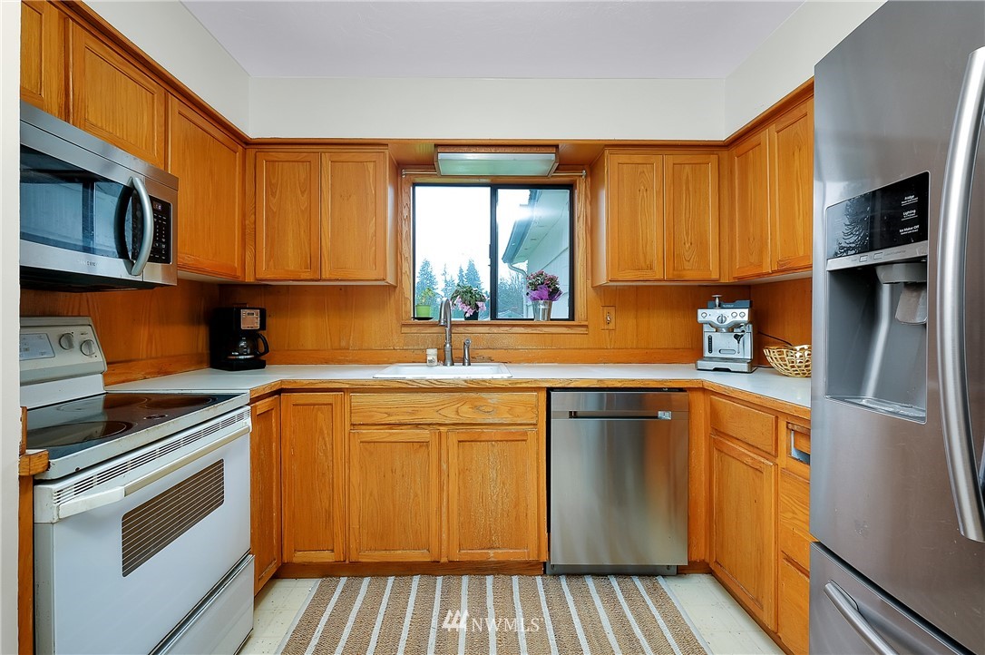 3530 Pine Road Bremerton, WA 98310 - Photo 11 of 34 a kitchen with stainless steel appliances granite countertop a stove a sink and a microwave