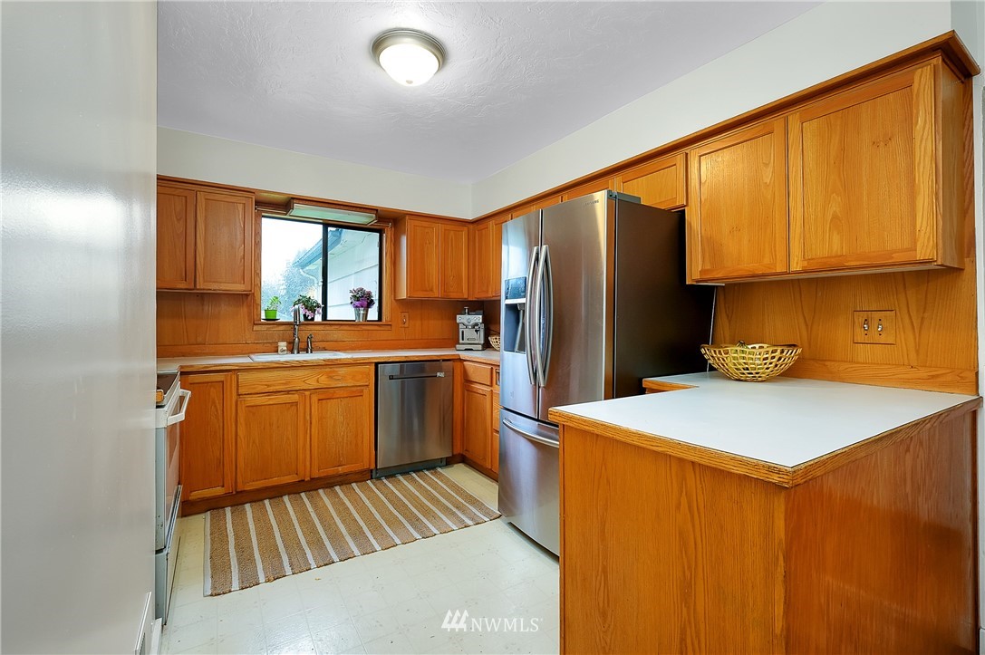 3530 Pine Road Bremerton, WA 98310 - Photo 12 of 34 a kitchen that has a sink and a refrigerator