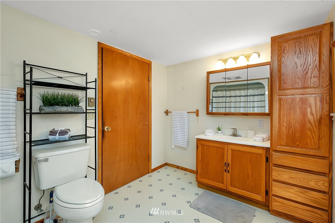 3530 Pine Road Bremerton, WA 98310 - Photo 22 of 34 a bathroom with a granite countertop sink toilet a mirror and shower
