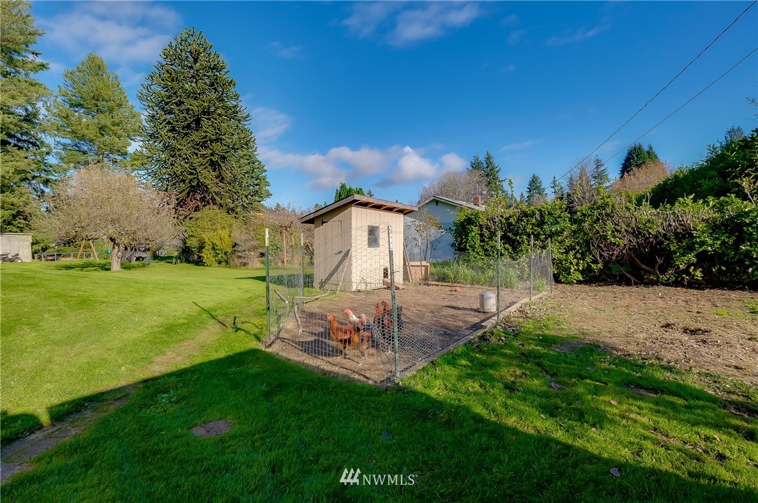 3530 Pine Road Bremerton, WA 98310 - Photo 6 of 34 a view of a garden with a building in the background