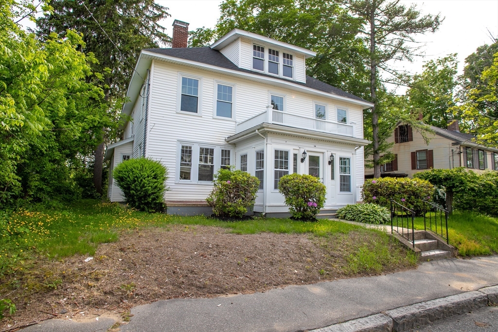 a front view of a house with garden and porch