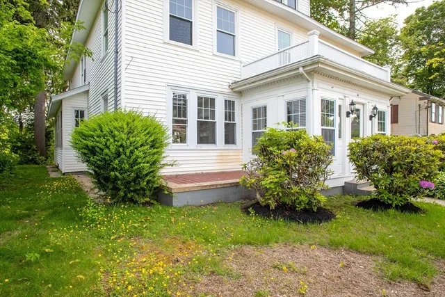 a front view of a house with a garden