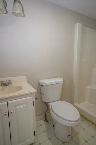 a white toilet sitting next to a bathroom sink