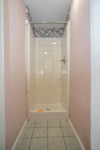 a bathroom with a glass shower door