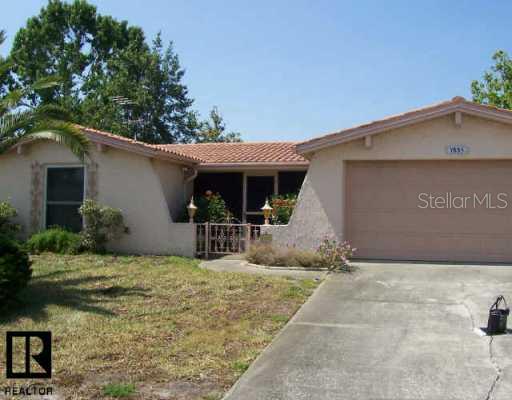 7835 Prairie Drive Port Richey, FL 34668 - Photo 1 of 1 a view of a house with porch and furniture