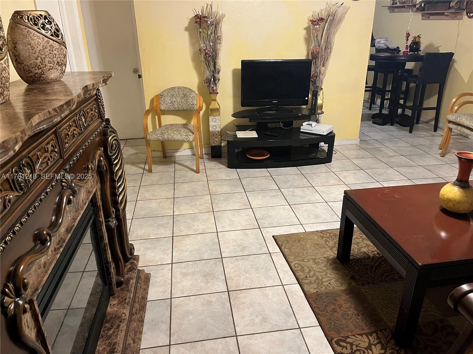 6546 Southwest 20th Court Miramar, FL 33023 - Photo 11 of 19 a living room with furniture and a flat screen tv