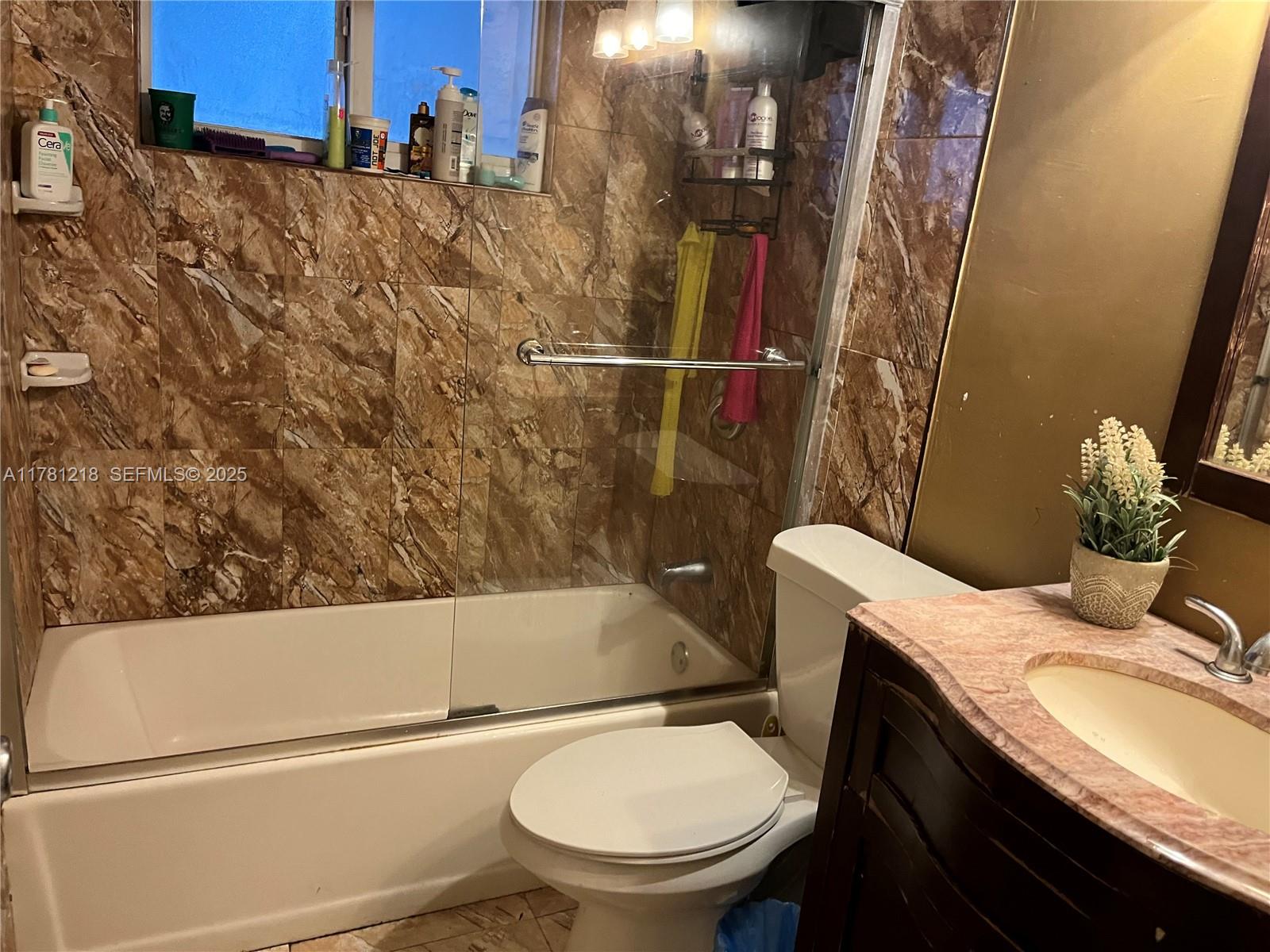 6546 Southwest 20th Court Miramar, FL 33023 - Photo 16 of 19 a bathroom with a sink a toilet and shower