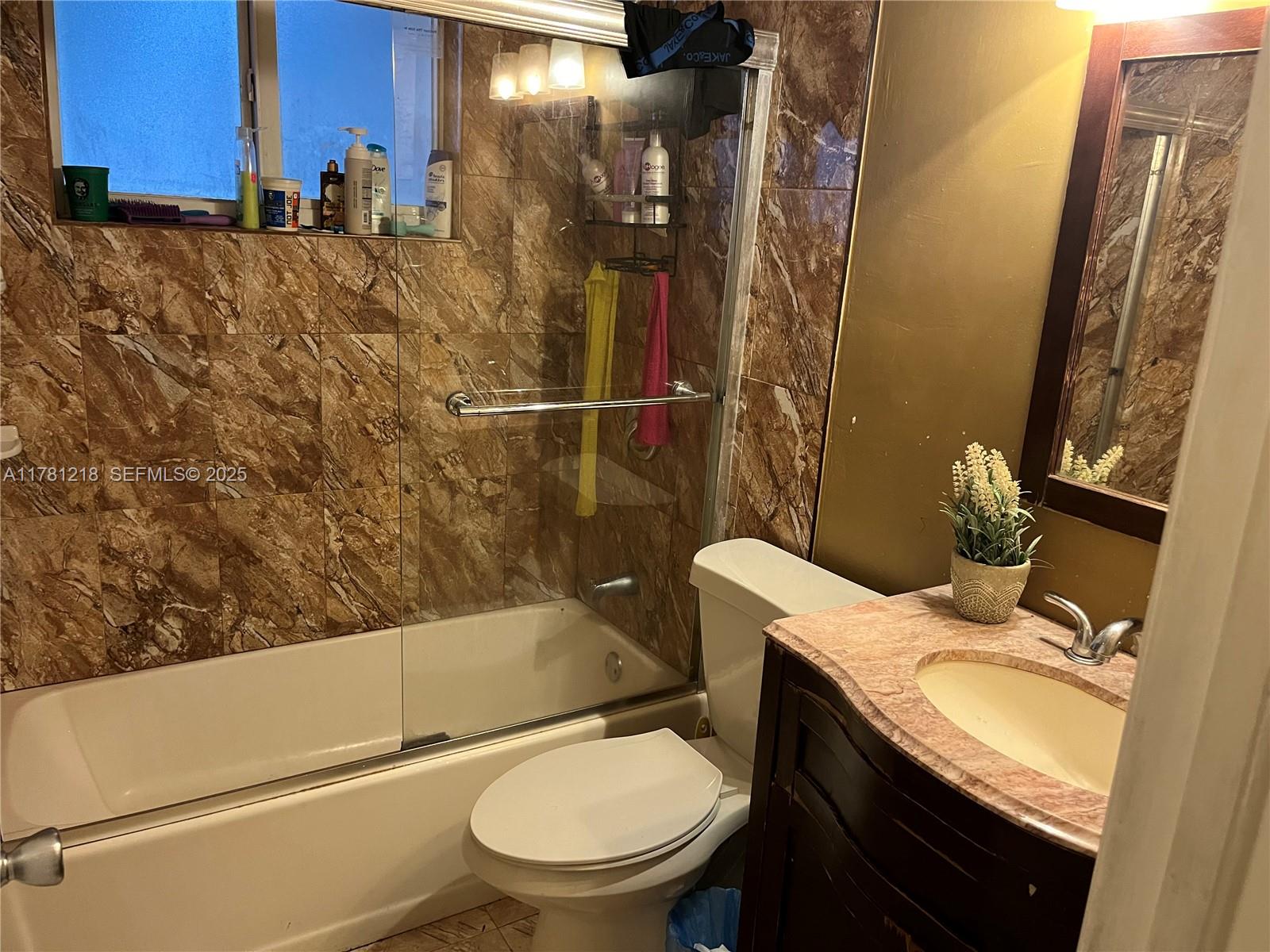 6546 Southwest 20th Court Miramar, FL 33023 - Photo 17 of 19 a bathroom with a granite countertop sink toilet and shower