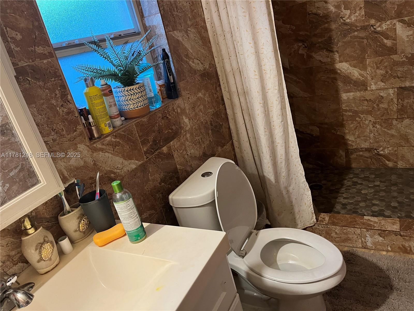 6546 Southwest 20th Court Miramar, FL 33023 - Photo 5 of 19 a bathroom with a toilet and a sink