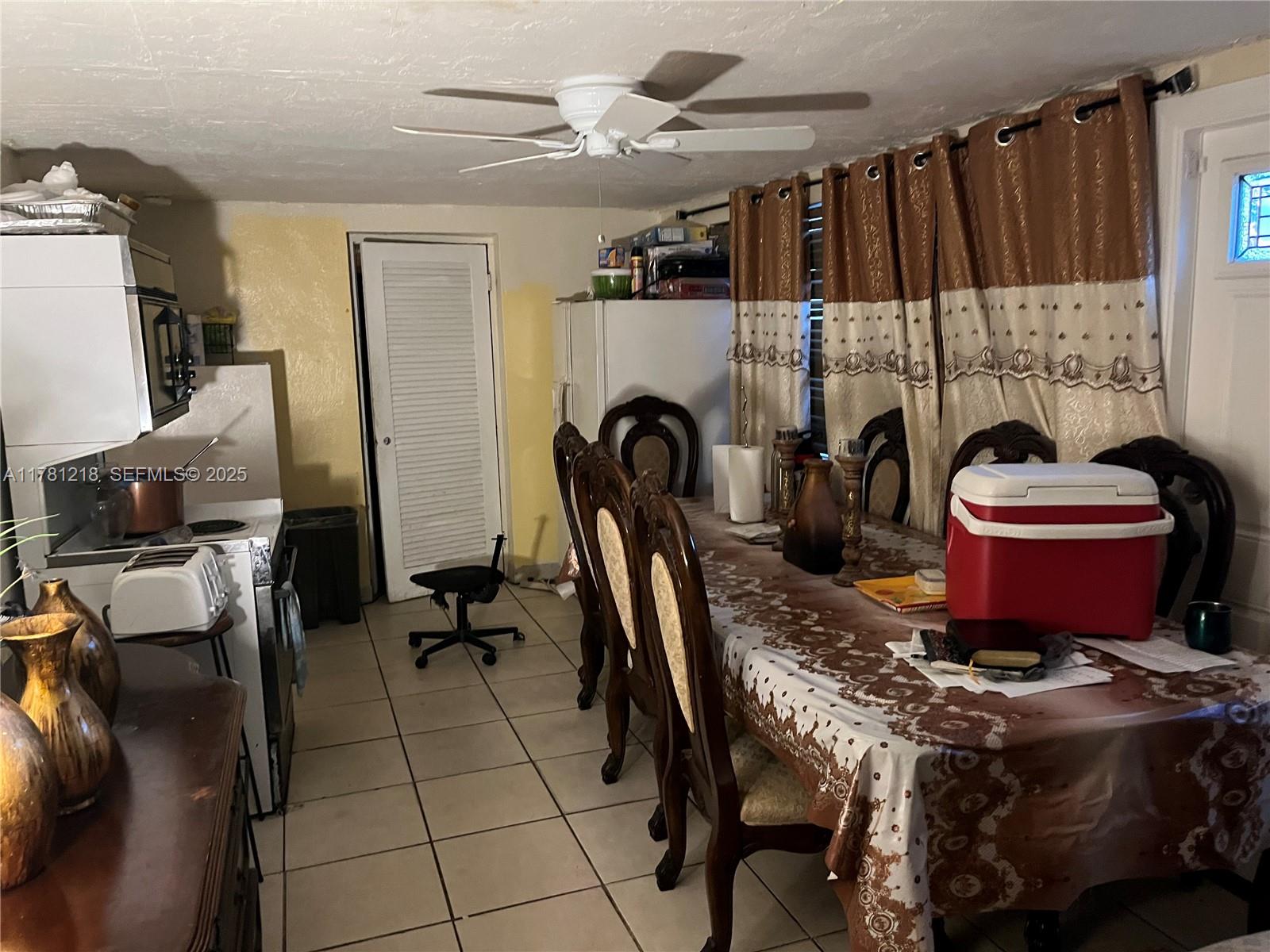 6546 Southwest 20th Court Miramar, FL 33023 - Photo 9 of 19 a dining room with furniture and a fireplace