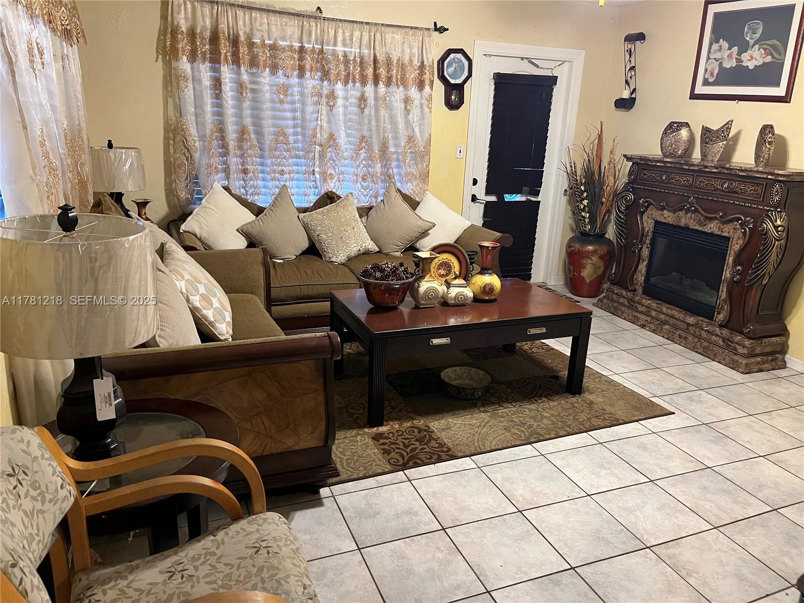6546 Southwest 20th Court Miramar, FL 33023 - Photo 10 of 19 a living room with furniture and a fireplace