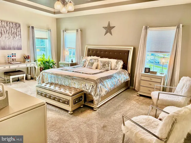 a bedroom with a bed and a chandelier