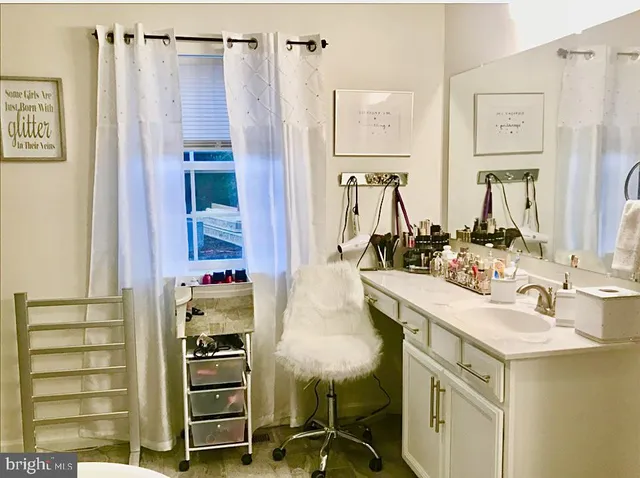 a bathroom with a double vanity sink and a mirror