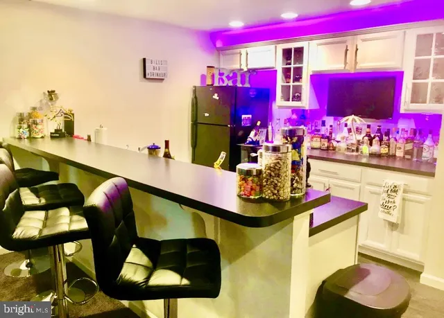 a view of a dining room with furniture and a chandelier