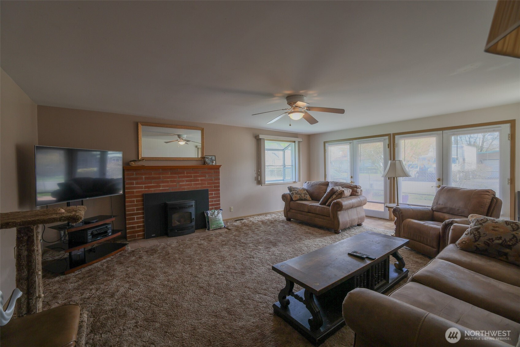 16110 178th Avenue Southeast Monroe, WA 98272 - Photo 13 of 35 a living room with furniture a flat screen tv and a fireplace
