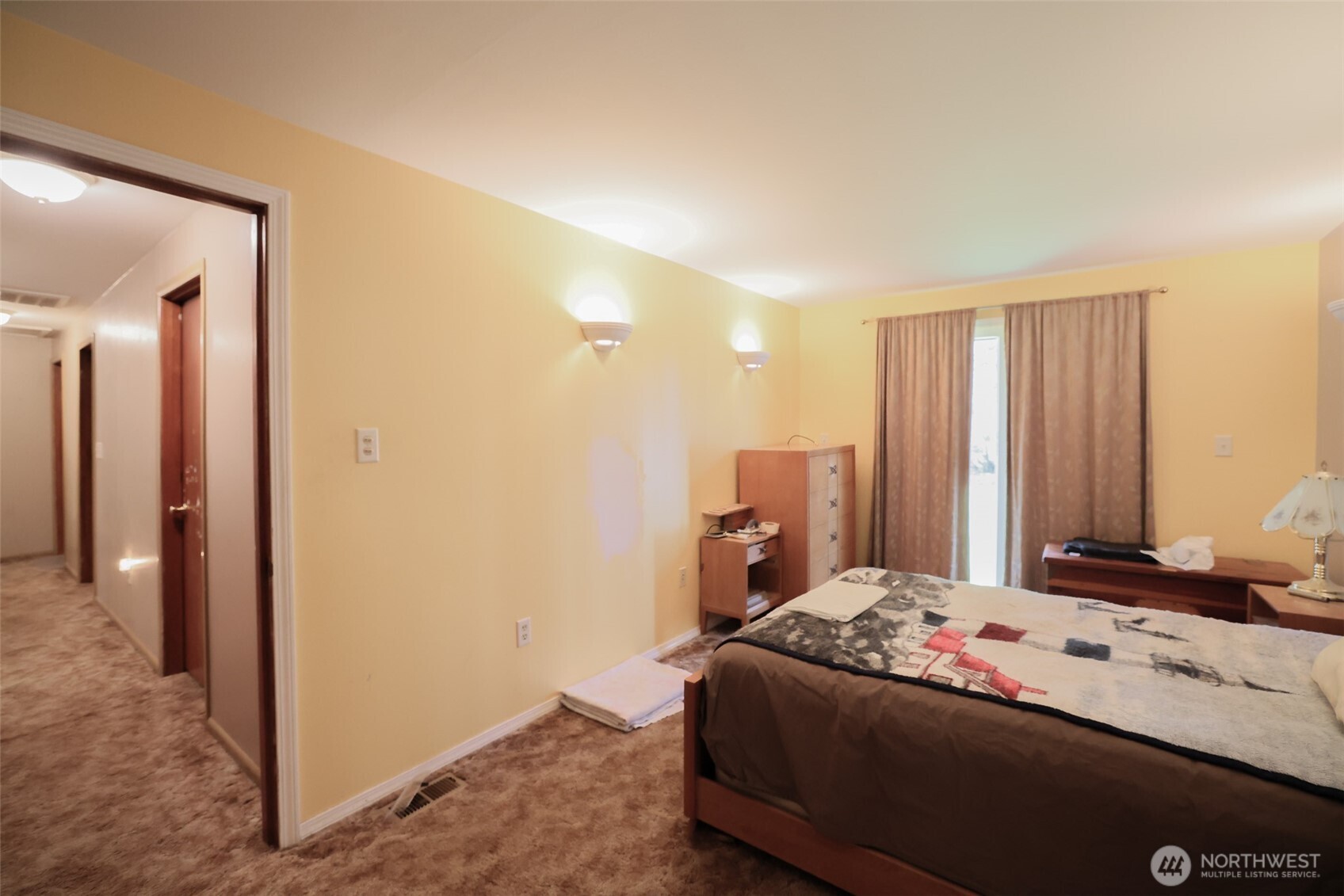 16110 178th Avenue Southeast Monroe, WA 98272 - Photo 16 of 35 a bedroom with a bed and a chandelier