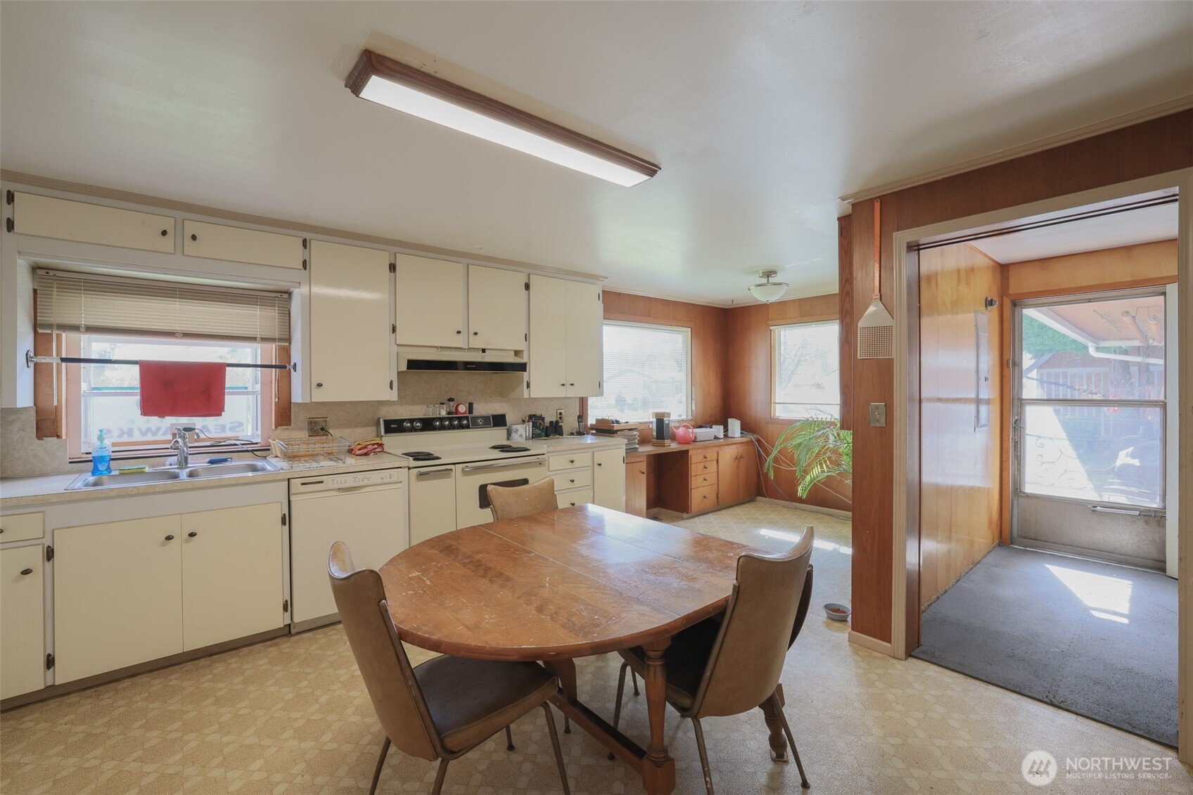 16110 178th Avenue Southeast Monroe, WA 98272 - Photo 8 of 35 a kitchen with stainless steel appliances granite countertop a stove a refrigerator a sink a dining table and chairs