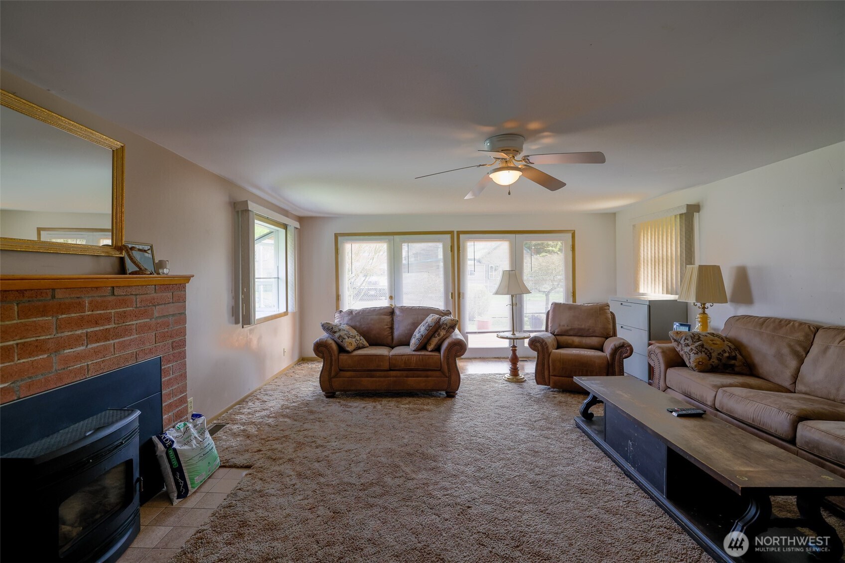 16110 178th Avenue Southeast Monroe, WA 98272 - Photo 10 of 35 a living room with furniture a fireplace and a window