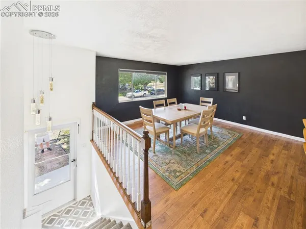 a view of a livingroom with furniture window and wooden floor