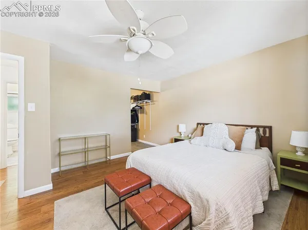 a bedroom with a bed and wooden floor