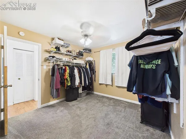 a view of walk in closet with clothes