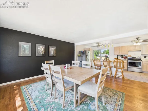 a view of a dining room with furniture and wooden floor