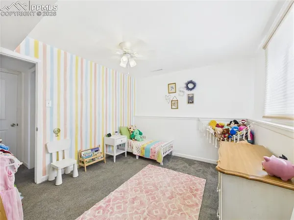 a bedroom with furniture and a rug