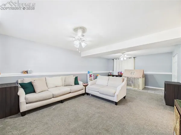 a living room with furniture and a chandelier