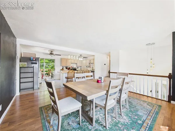 a dining room with furniture and wooden floor
