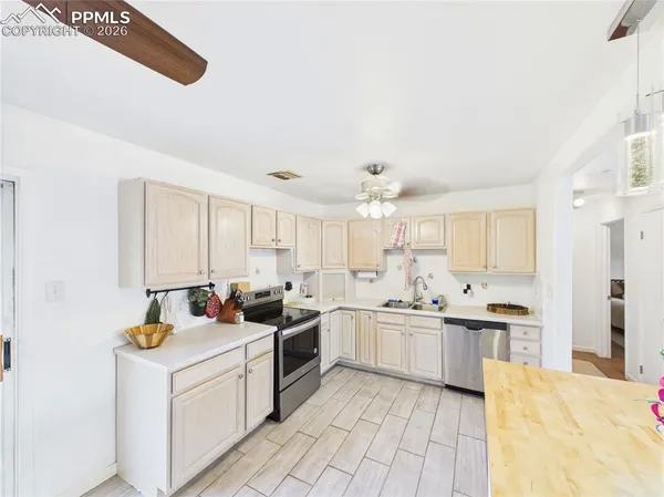 a kitchen with stainless steel appliances kitchen island granite countertop a sink and cabinets
