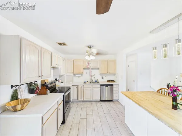 a kitchen with a sink stove and cabinets