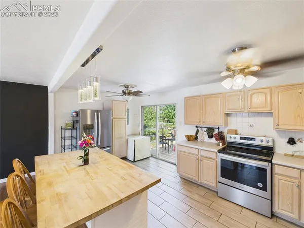 a kitchen that has a lot of cabinets a sink and appliances