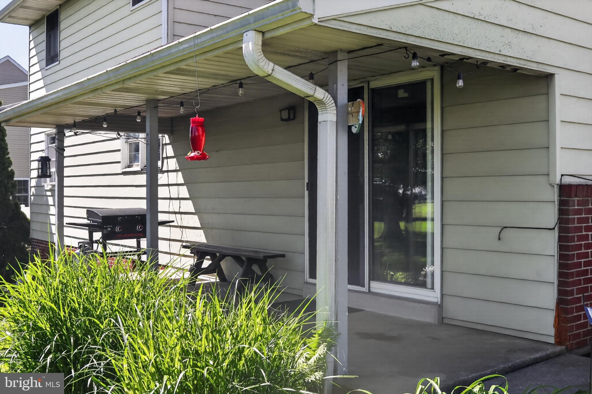 1106 Village Road Lancaster, PA 17602 - Photo 32 of 42 Charming porch with lush greenery.