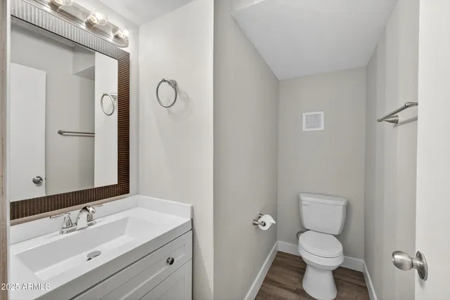 a bathroom with a sink toilet a mirror and shower