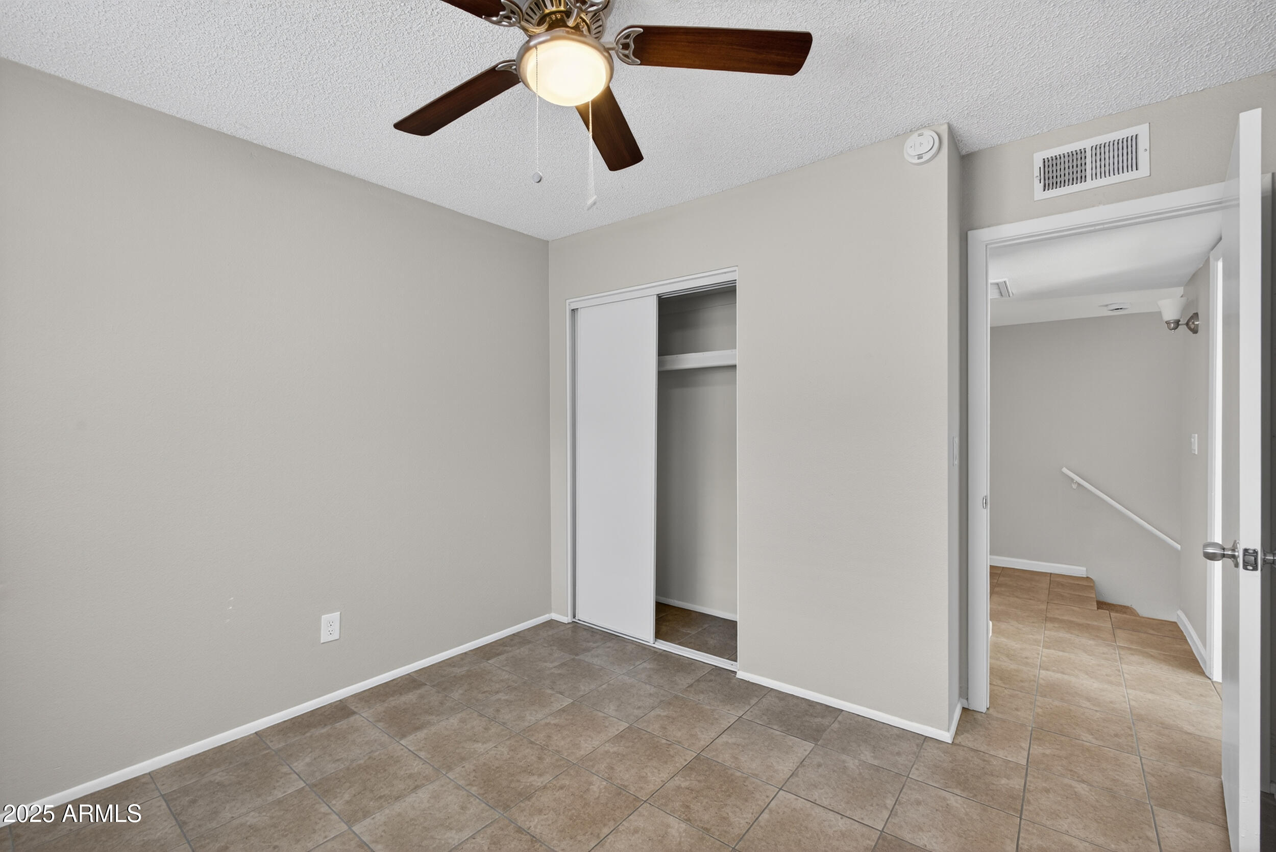 860 East Brown Road, Unit 66 Mesa, AZ 85203 - Photo 21 of 30 an empty room with closet and a chandelier fan