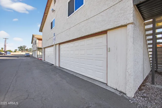 a view of a house with a yard and palm trees