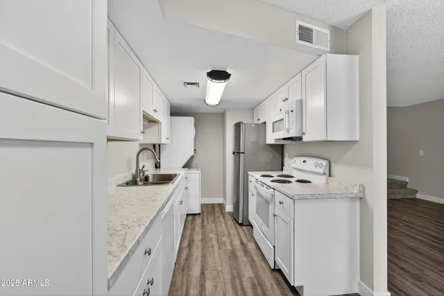 a kitchen with stainless steel appliances granite countertop a stove and a sink