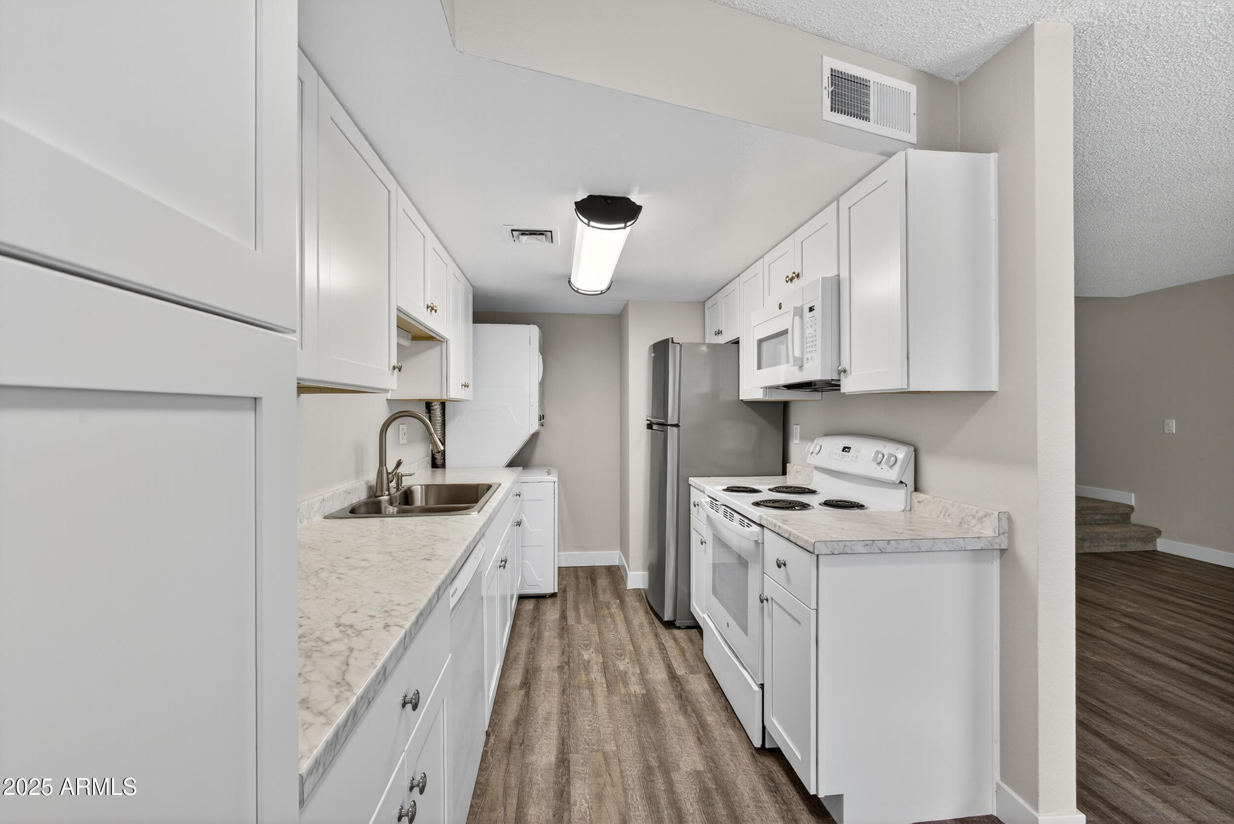860 East Brown Road, Unit 66 Mesa, AZ 85203 - Photo 7 of 30 a kitchen with stainless steel appliances granite countertop a stove and a sink