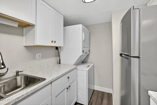 a kitchen with a refrigerator sink and cabinets